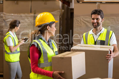 Portrait of workers are holding cardboard boxes and looking each