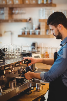 Man taking coffee from espresso machine