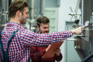 Maintenance workers examining pressure