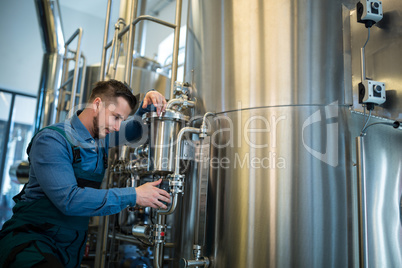 Brewer checking pressure at brewery