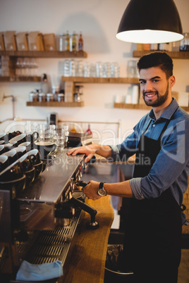 Man taking coffee from espresso machine