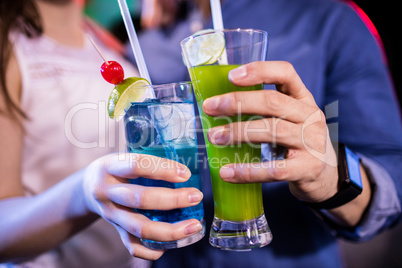 Couple holding cocktail glasses
