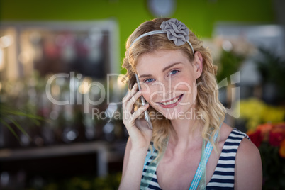 Female florist talking on mobile phone