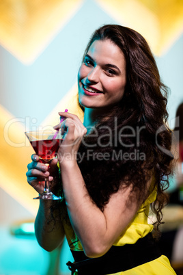 Beautiful woman having a red martini