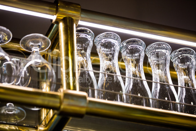 Wine glass and beer glass arranged on bar rack