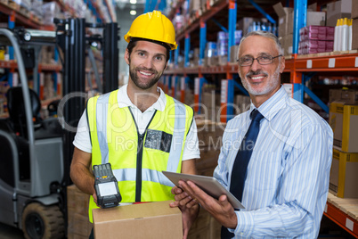 Businessman and warehouse worker