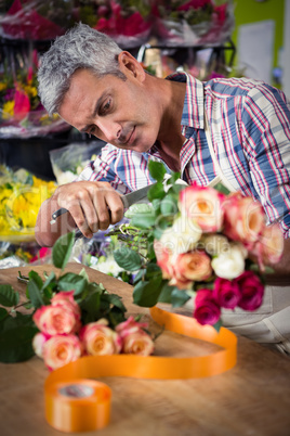 Male florist preparing bouquet of flower