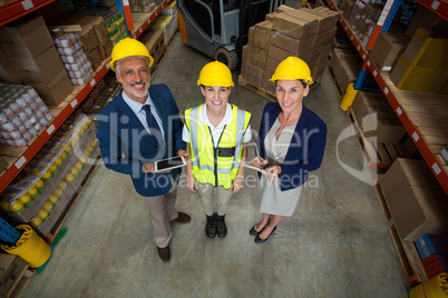 High angle view of managers and worker wearing hard hat and look