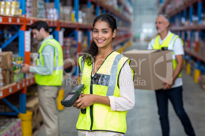 Happy worker posing and smiling to the camera in front of her co