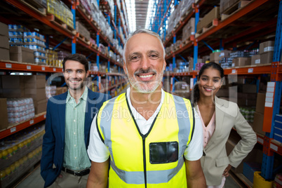 Focus of worker is smiling and posing in front of his managers