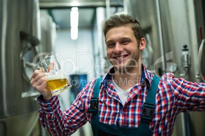 Brewer holding a glass of pint beer