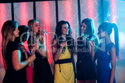 Group of smiling friends having glass of champagne