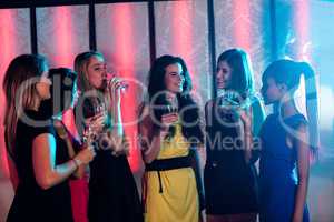 Group of smiling friends having glass of champagne