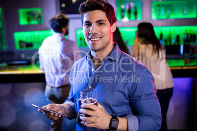 Portrait of man holding mobile phone and beer mug