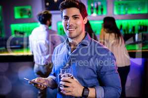 Portrait of man holding mobile phone and beer mug