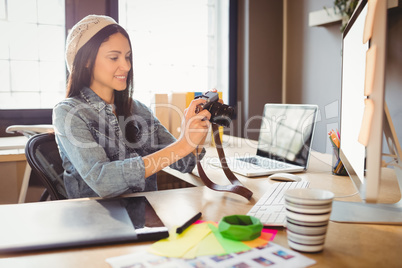 Graphic designer looking at pictures in digital camera