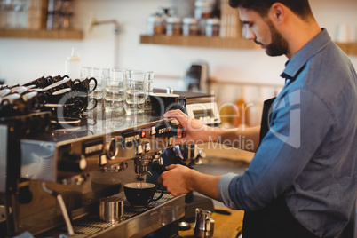 Man taking coffee from espresso machine