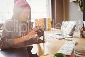 Graphic designer looking at pictures in digital camera