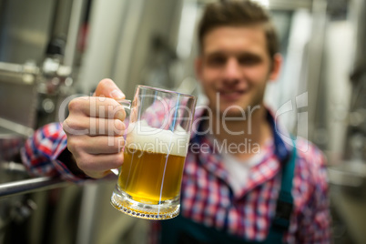 Brewer holding a glass of pint beer