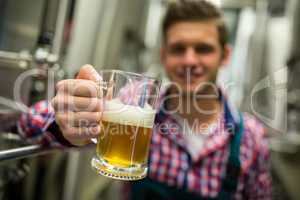 Brewer holding a glass of pint beer