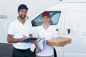 Portrait of delivery people are holding goods and smiling to the