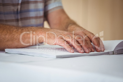 Senior man using braille to read