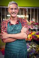 Male florist with arms crossed at flower shop