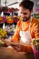 Male florist using digital tablet