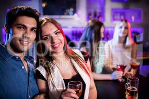 Smiling friends having a glass of wine in bar