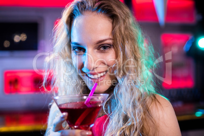 Portrait of beautiful woman holding cocktail glass