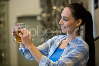 Close-up of female brewer testing beer