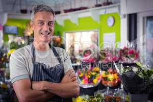 Male florist standing with arms crossed