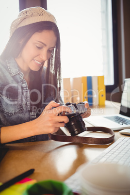 Graphic designer looking at pictures in digital camera