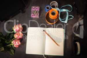 Open diary and florist accessories on the table