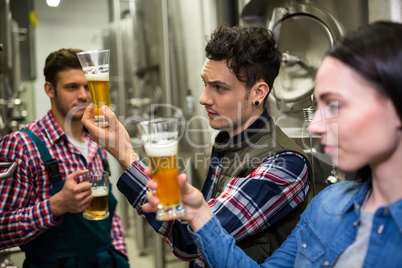 Brewers testing beer at brewery factory