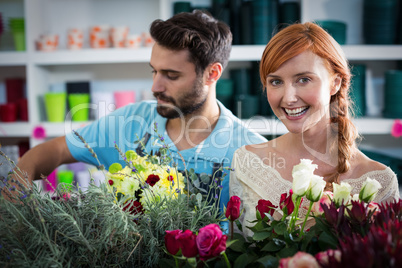 Happy couple arranging flowers