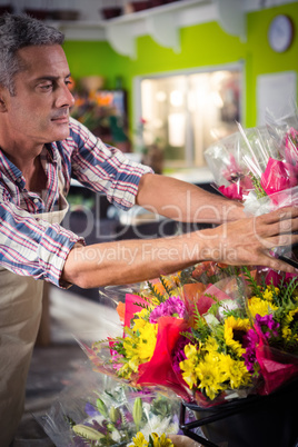 Male florist arranging bouquet of flower