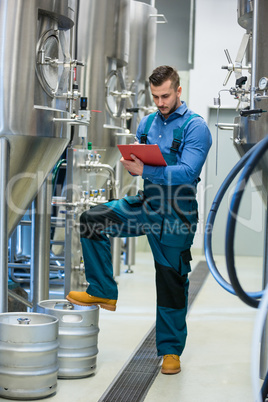 Maintaince worker wrting on clipboard