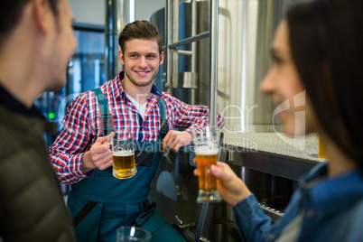 Brewers testing beer at brewery factory