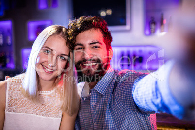 Smiling friends posing for a selfie Smiling friends posing for a selfie