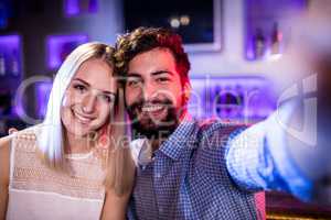 Smiling friends posing for a selfie