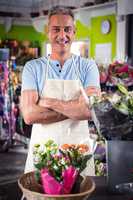 Male florist standing with arms crossed