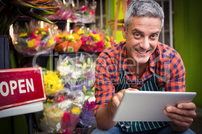 Male florist using digital tablet