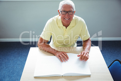 Senior man using braille to read