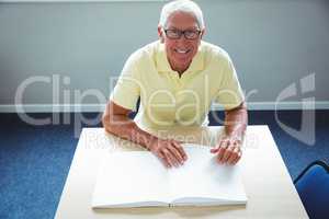 Senior man using braille to read