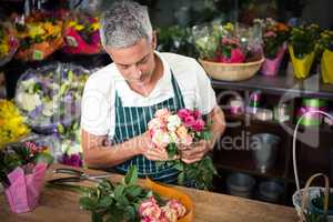 Male florist holding bunch of roses