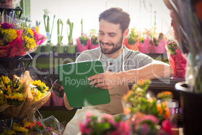 Male florist writing and making notes