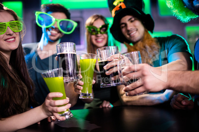 Group of friends toasting beer mugs and drink glasses