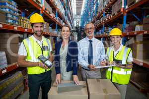 Businessmen and warehouse workers