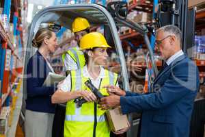 Businessman controlling digital device of worker